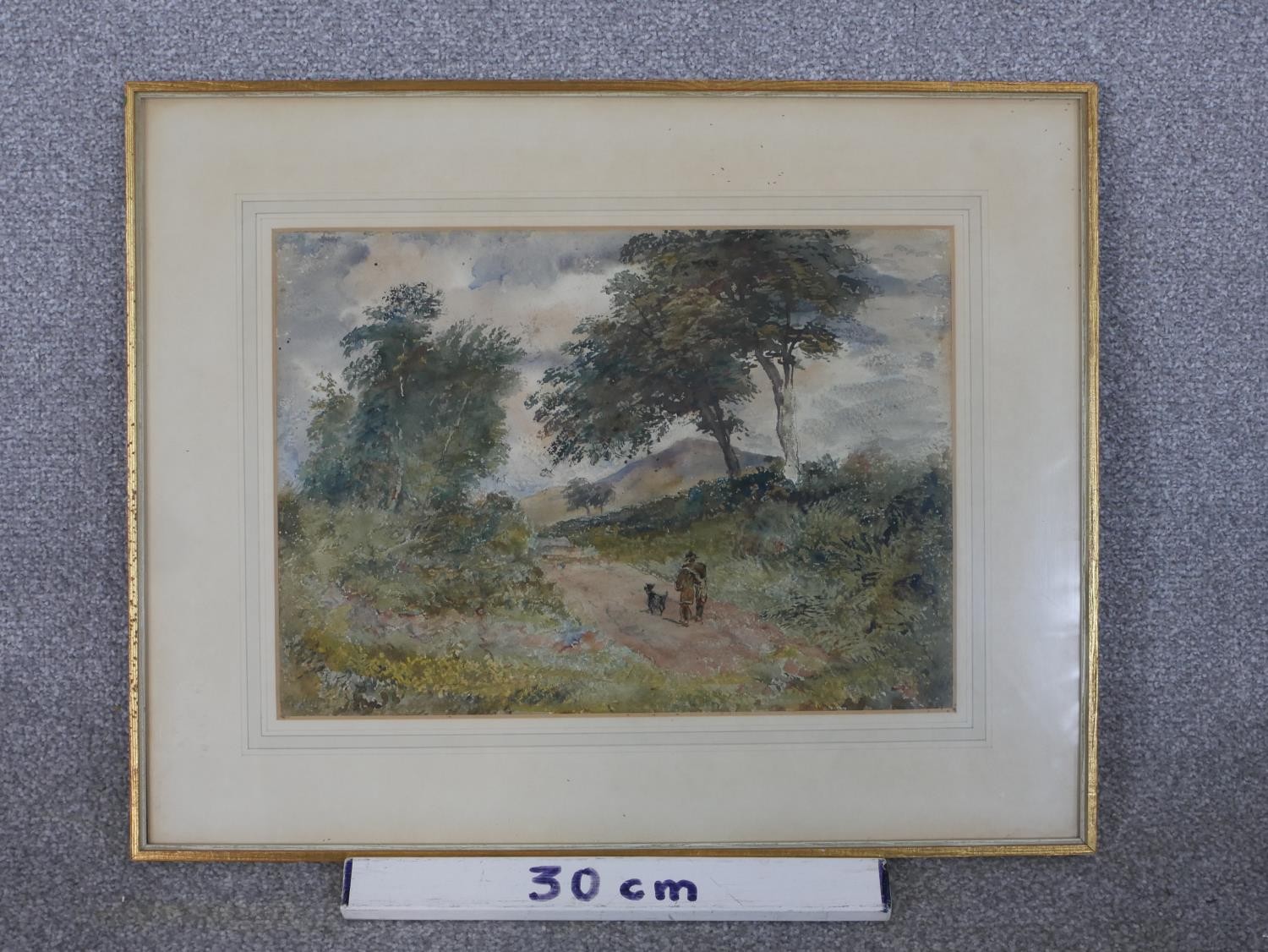 A framed and glazed watercolour of a countryside path with man and his dog, indistinctly signed. H. - Image 3 of 5