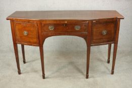 A Regency mahogany bow front sideboard, with a central drawer flanked by two deep drawers on