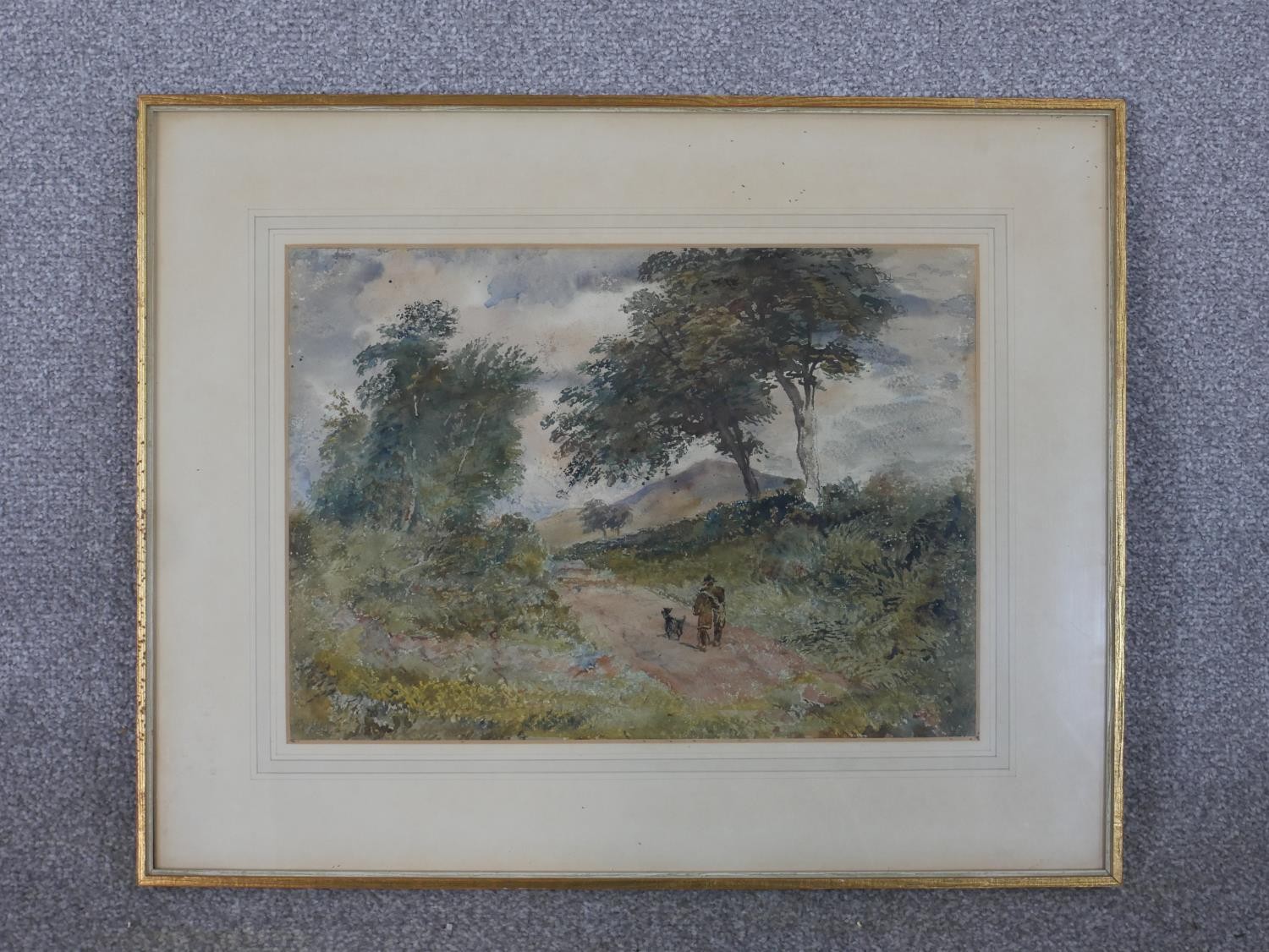 A framed and glazed watercolour of a countryside path with man and his dog, indistinctly signed. H. - Image 2 of 5