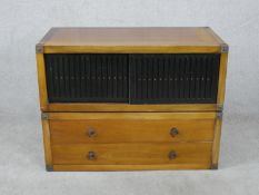 A late 20th century Chinese hardwood side cabinet, with a pair of sliding grille doors, above two