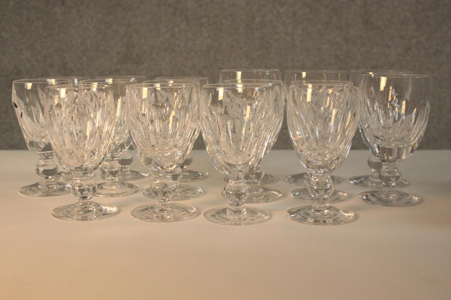 A group of sixteen 19th century Waterford crystal drinking glasses, with cut bowls and a single