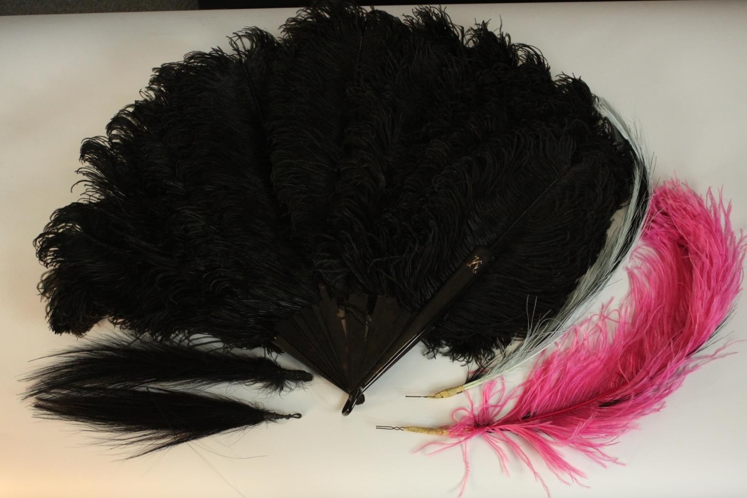 A vintage Selfridges hat box containing an early 20th century black ostrich feather fan with