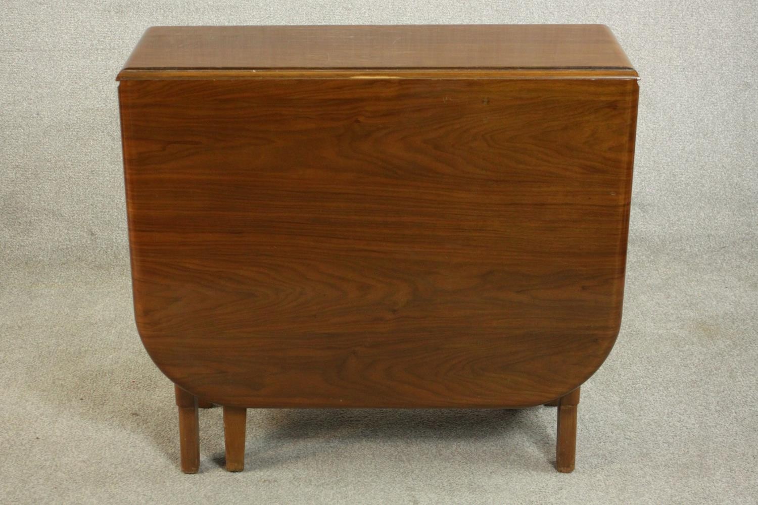 A mid 20th century walnut drop leaf dining table, the two leaves with rounded corners on a base with - Image 6 of 9