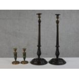 A pair of carved fluted and twist design candlesticks with brass holders along with a pair of