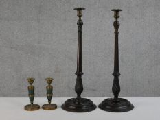 A pair of carved fluted and twist design candlesticks with brass holders along with a pair of