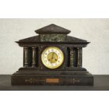 A Victorian slate marble mantel clock of architectural form with green marble pillars, French