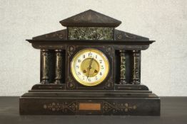 A Victorian slate marble mantel clock of architectural form with green marble pillars, French