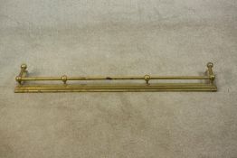 A Victorian brass fender of typical form with ball supports to the tubular rail. H.10 W.123 D.20cm.