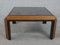 An unusual G-Plan teak coffee table of square form with a weathered effect top. H.35 W.75 D.75cm