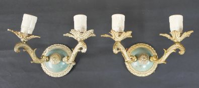 A pair of 19th century style brass wall lights, each with two scrolling branches and stiff leaf drip