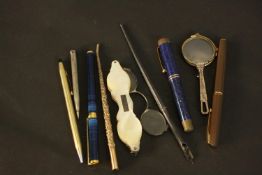A collection of vintage and antique pens and other items. A mother of pearl cased pair of