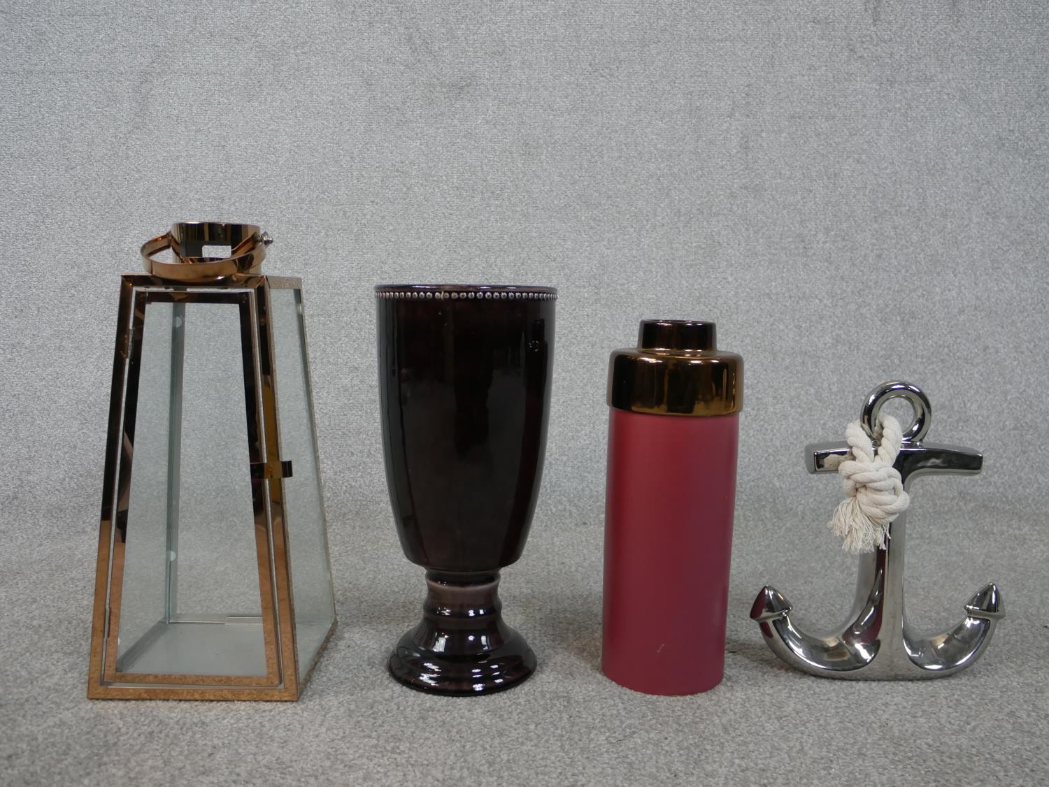 A Boconcept maroon and bronze glaze vase, a silver glaze anchor with rope, a copper and glass
