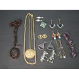 A collection of costume and antique jewellery, including a pierced and carved faux tortoiseshell