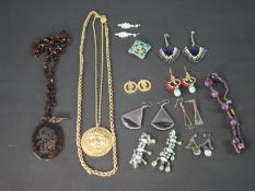 A collection of costume and antique jewellery, including a pierced and carved faux tortoiseshell