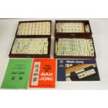 A bone early 20th century Mah Jong set with instructions and other manuals. H.2 W.22 D15.5cm. (
