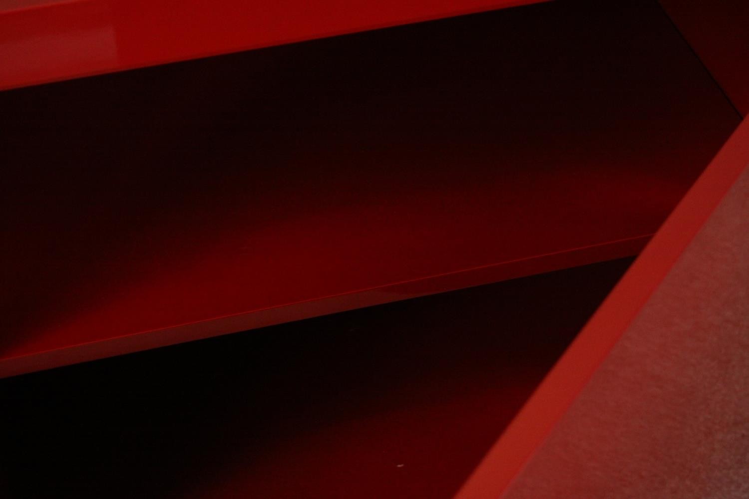 A contemporary red lacquered sideboard with two cupboard doors, on black lacquered supports. H.74 - Image 5 of 14