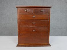 An early 20th century walnut tabletop apprentice piece or collectors chest, of two short over four