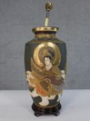 An early 20th century Japanese Satsuma pottery table lamp, decorated with typical figures and gilded