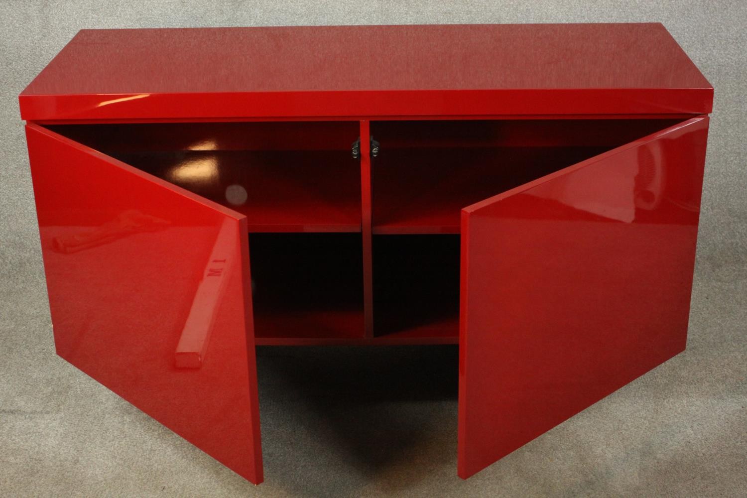 A contemporary red lacquered sideboard with two cupboard doors, on black lacquered supports. H.74 - Image 3 of 14