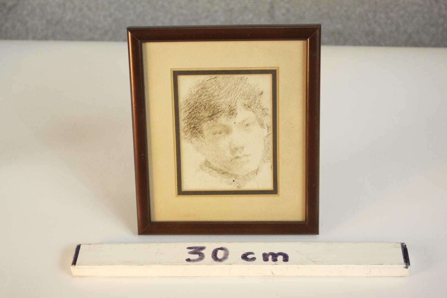 A framed and glazed pen drawing of a young boy, unsigned. H.20 W.17cm. - Image 3 of 5