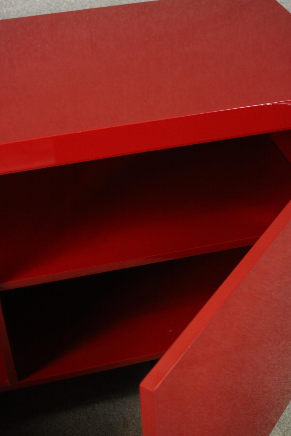 A contemporary red lacquered sideboard with two cupboard doors, on black lacquered supports. H.74 - Image 6 of 14