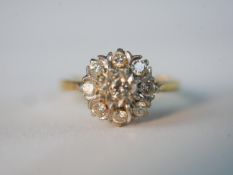 An Edwardian 18ct yellow gold and platinum diamond cluster ring, set with nine round old cut