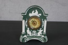 A Wedgwood Jasperware style Classical design ceramic clock with gilt metal face and surround. H.18