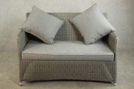 A contemporary grey painted Lloyd Loom style two seater sofa, with loose grey upholstered seat