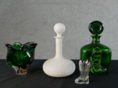 A green and white swirl art glass decanter and circular stopper. a frosted white opaque glass