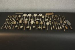 A collection of various silver plate cutlery, including a knife sharpener with antler handle, shoe