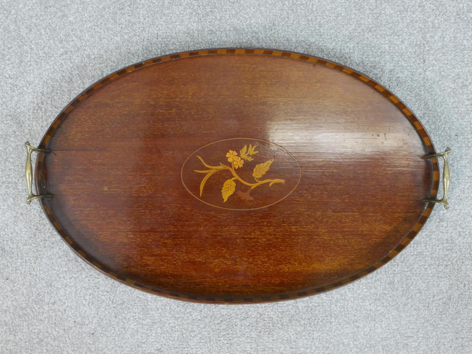 An Edwardian walnut and marquetry inlaid oval tray, with two brass handles, the centre inlaid with a - Image 2 of 4