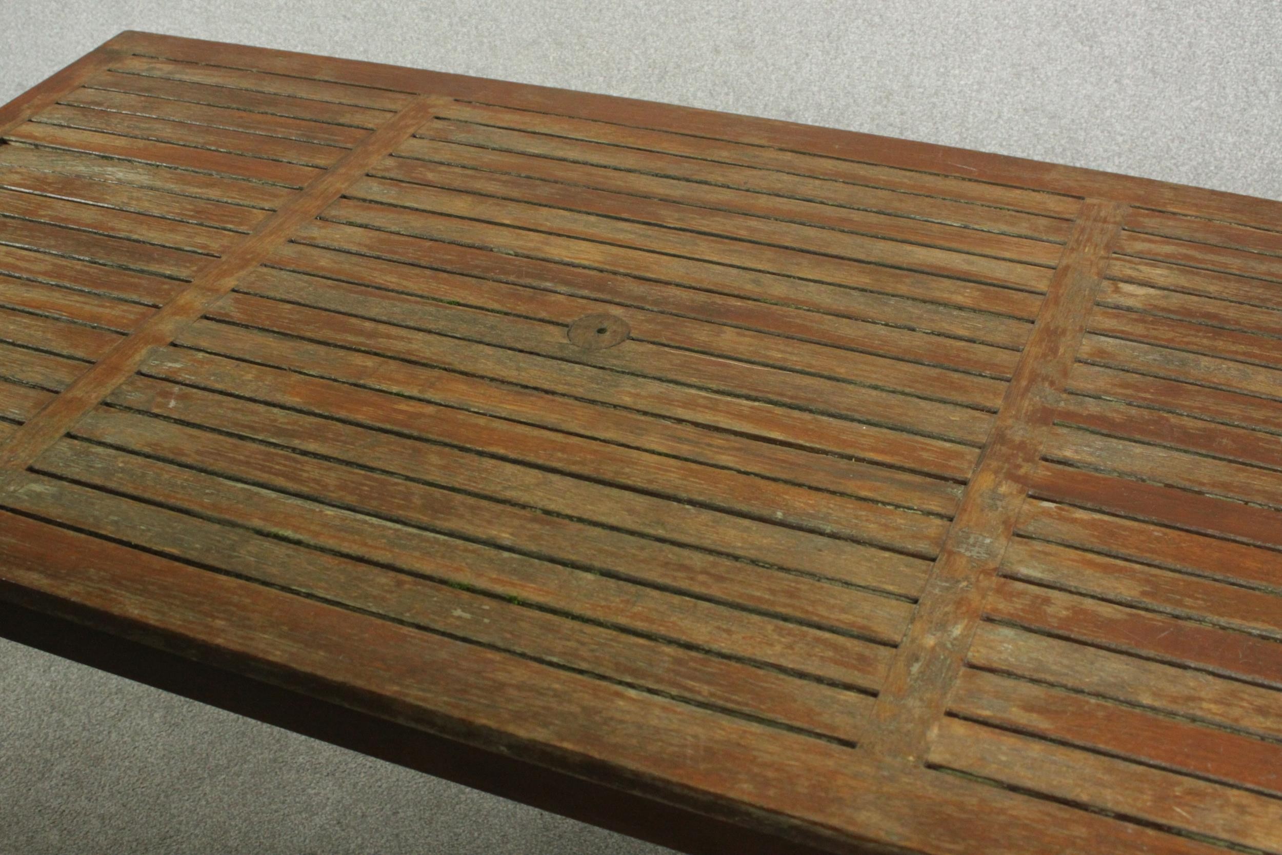 A contemporary teak garden dining table, with a rectangular slatted top on square section legs. H.69 - Image 3 of 4