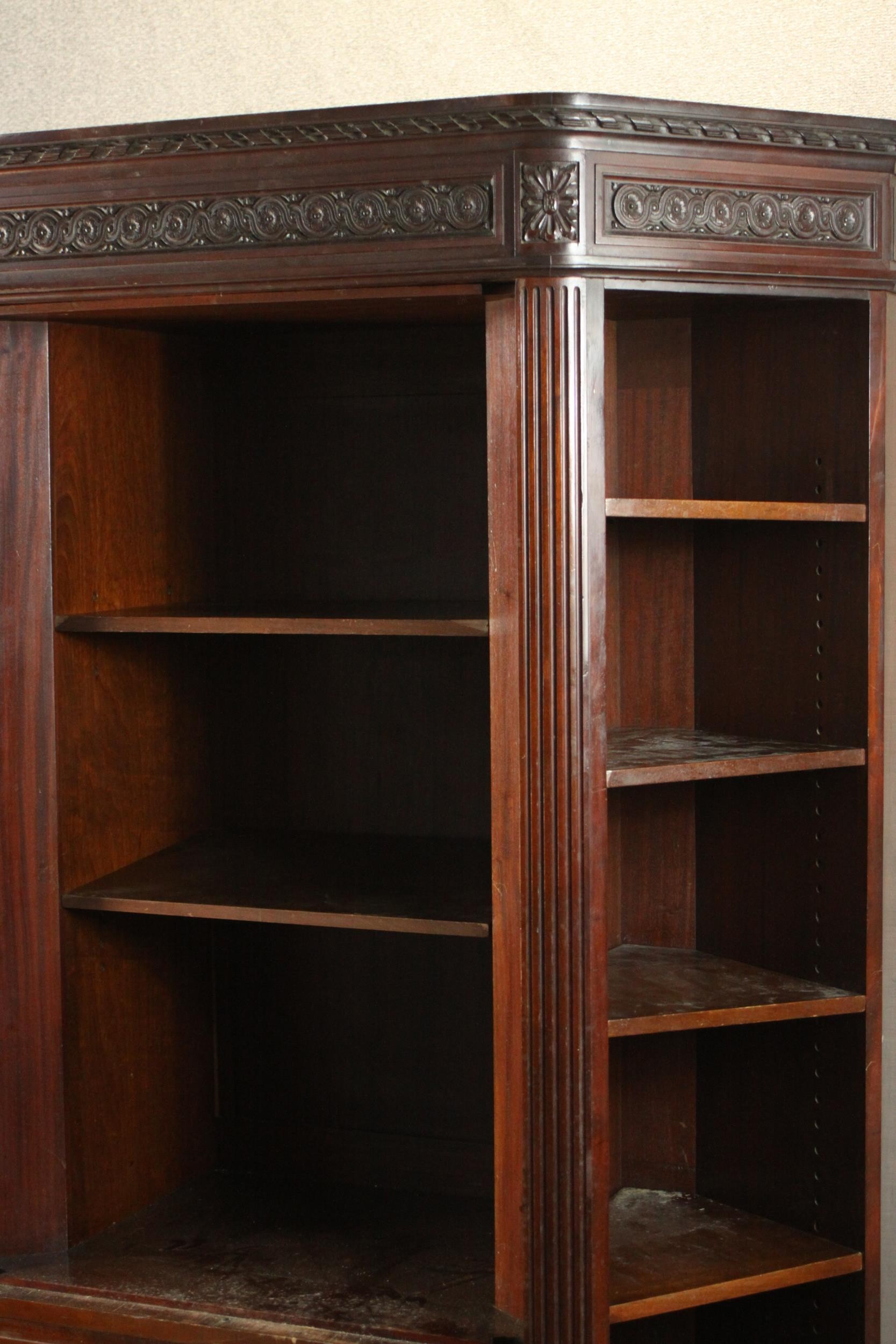 A Continental walnut bookcase with open shelves above drawers on tapering reeded supports. (back - Image 4 of 9