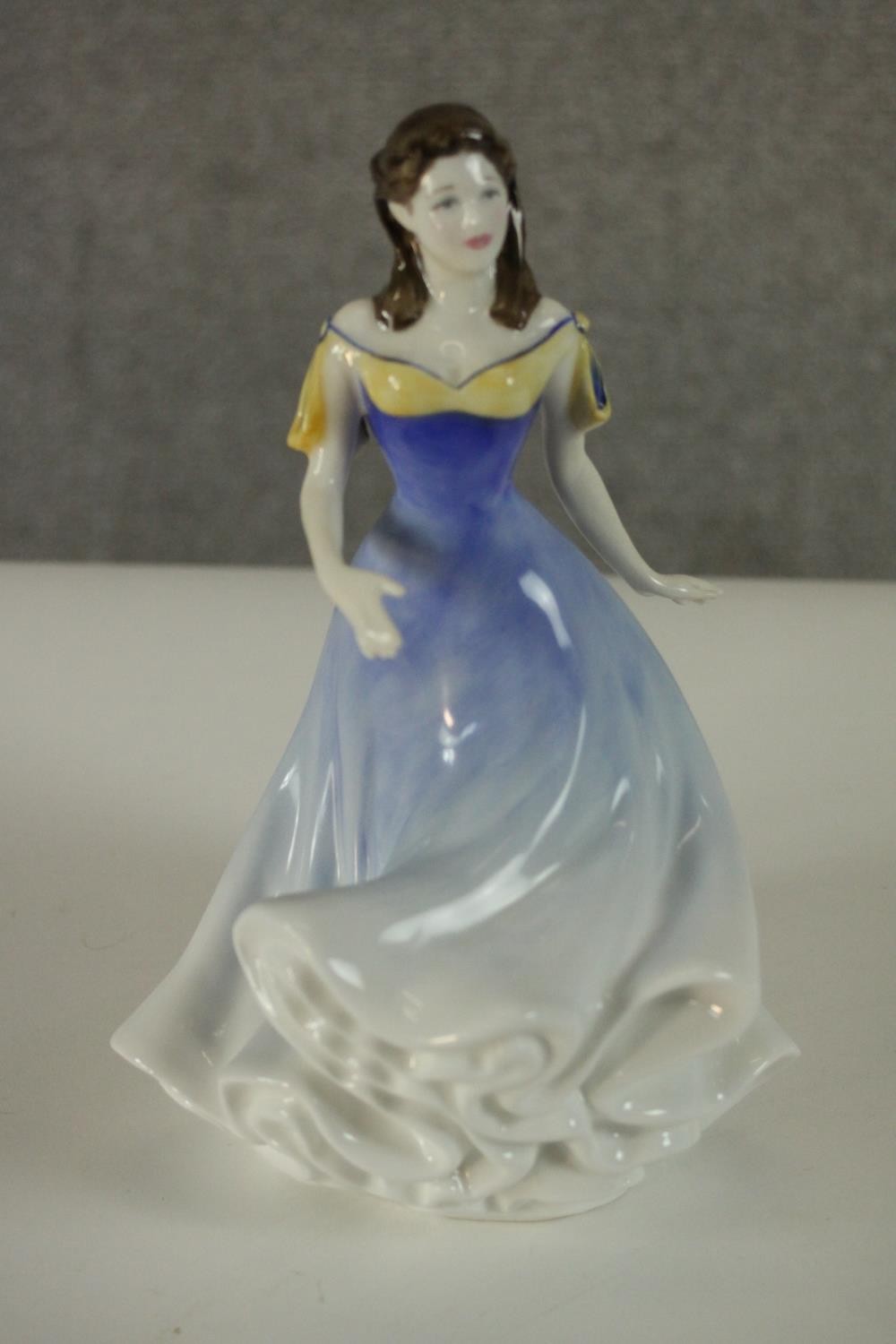A collection of fifteen hand painted porcelain figures of ladies in a variety of coloured outfits by - Image 25 of 27