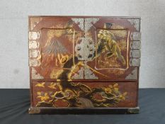 A Meji period Japanese gilded lacquer table cabinet, the front depicting mount Fuji and a falcon