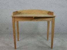 A late 19th century/early 20th century pine side table, with a 3/4 gallery and on square section