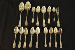 A collection of silver and silver plated cutlery, including a pair of gilded Georgian berry