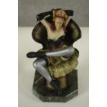 After Chiparus, an Art Deco style resin figure of a female dancer posing on a chair on marble effect