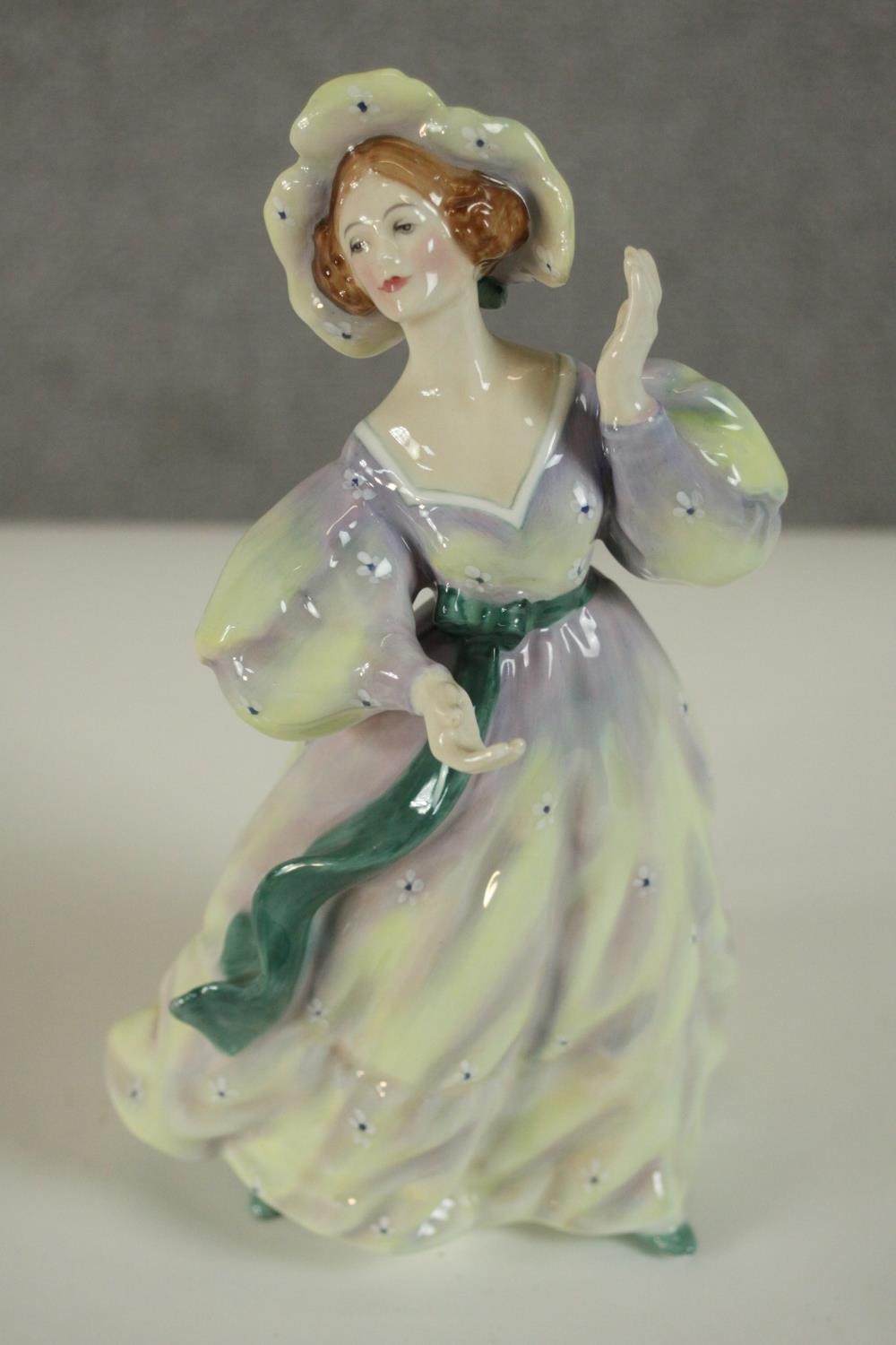 A collection of fifteen hand painted porcelain figures of ladies in a variety of coloured outfits by - Image 15 of 27