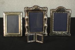 Four velvet backed repoussé silver frames. including a small foldable two frame picture frame.