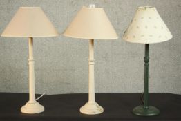 A pair of cream painted turned table lamps along with a dark green painted lamp. H.56 Dia.15cm. (