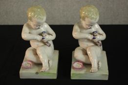 A pair of 19th century French Gien porcelain figures each depicting a baby feeding a bird. H.21 W.13