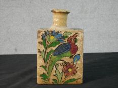 A Qajar hand painted polychrome earthenware bottle vase decorated with flowers and birds. H.15.5 W.9