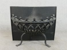 A wrought iron fire basket, of demi-lune form, with a rectangular back, on two curved legs. H.50 W.