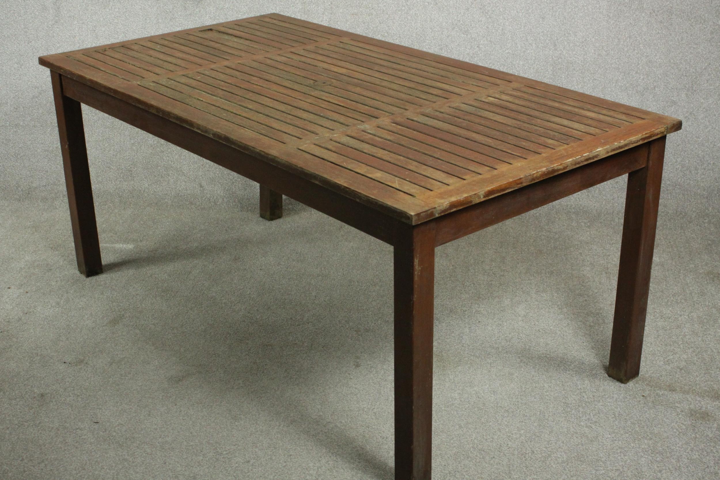 A contemporary teak garden dining table, with a rectangular slatted top on square section legs. H.69 - Image 4 of 4