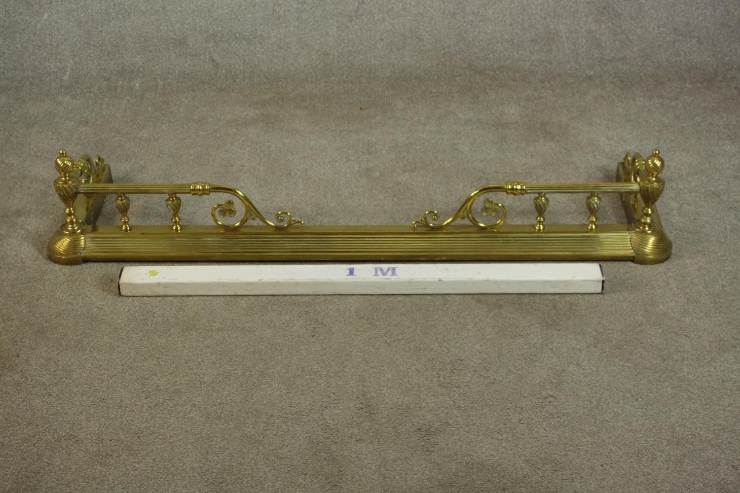 A late 19th/early 20th century brass fender, with wrythen urn supports, the rails terminating in - Image 2 of 6