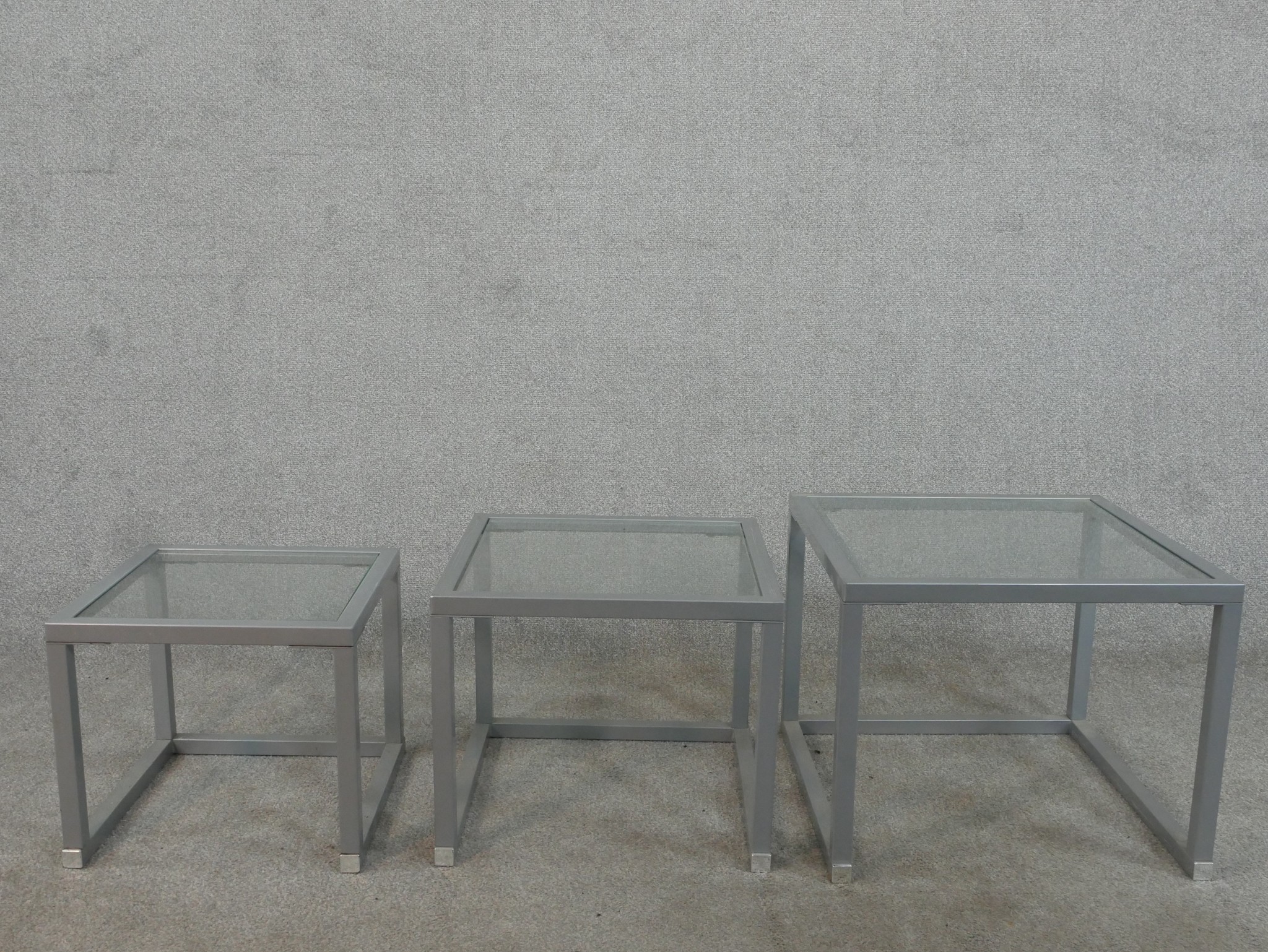 A contemporary nest of three occasional tables, of square form with plate glass tops and square - Image 2 of 3