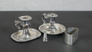 A pair of late 19th - early 20th Century silver plate candleholders, one including a snuffer along