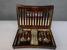 A six person oak canteen containing a silver plated fish set with ivorine handles. Blades engraved