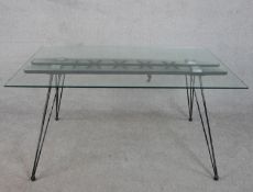 A 20th century dining table, with a rectangular plate glass top, the base woven together with rope